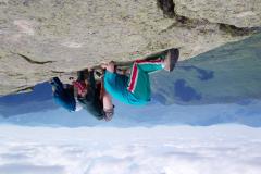 photo inverted, with land at the top, sky below, and 3 hikers with their heads inverted to the rock