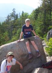 Phil seated on boulder with Kevin beside