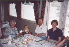 Grandma, Will (in high chair), Greg, and DeeAnn, around the dining table