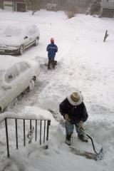 Two cars in the driveway; Phil and Kathy finishing up the shovelling.