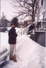 Phil working on the front steps while Dad holds a broom in front of Frodo (the car)