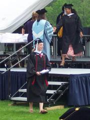 Jocelyn descends from the podium with diploma and towel in hand.