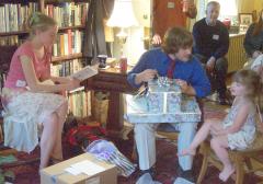 Jocelyn, Steve, and Hannah opening presents