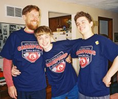 Scott, Phil, and Kevin pose together in their Red Sox Champions t-shirts.