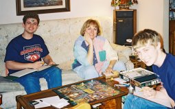 Kevin, Kathy, and Phil at the coffee table playing Clue