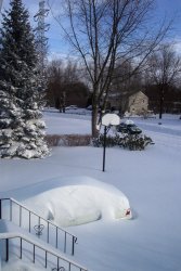 the car buried in snow as the sky clears