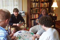 Steve, Kathy, and others around the table with the Sequence game.