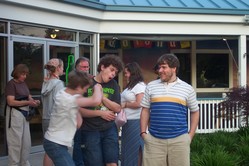 Outside the restaurant, Phil jabs at Kevin while Steve looks on.