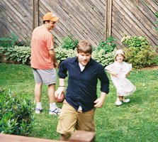 Steve runs away from Hannah, with football.