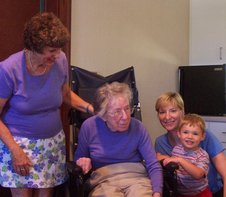 The pose has Great Grandma T in her wheelchair, with the others beside her.