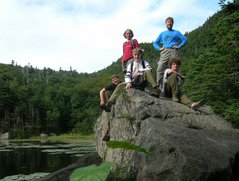 Steve, Jocelyn, Phil, Scott, and Kevin pose on a boulder beside Carter Lake.