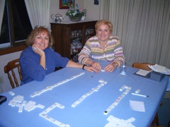 Kathy and Lidia at the dining room table, where dominoes are laid out in rows