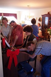 four young people playing the organ at once