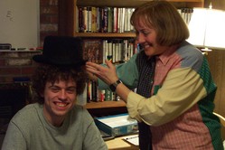 Kathy placing the top hat on Kevin's head
