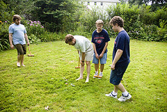 4 guys playing croquet