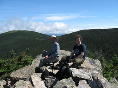 hikers sitting on a rocky summit