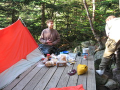 cooking gear and tent on platform