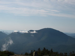 a round-topped mountain, with misty clouds hanging around