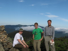three hikers on a summit