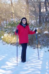 Lorissa on the snow, with ski poles
