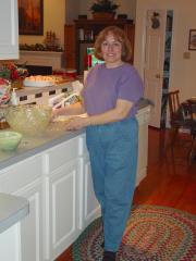 Kathy standing by the kitchen counter