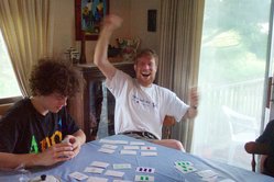 Scott waving happily with cards on the table, and Kevin.
