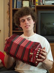 Kevin playing a red concertina