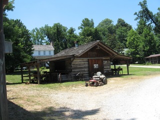 shack with riding mower in front